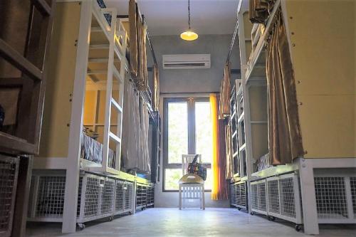 a large room with a large window and some shelves at Bali Bobo Hostel in Jimbaran