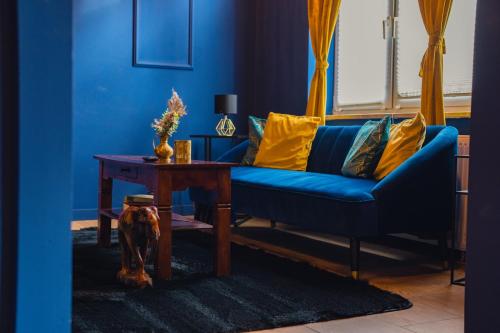 a blue living room with a blue couch and a table at Blue Royal Apartment in Celle