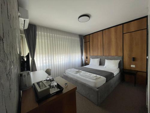 A bed or beds in a room at New Prishtina Luxury Rooms