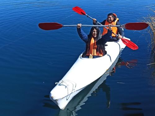 two people in a kayak on the water at Uros Waliski Lodge in Puno