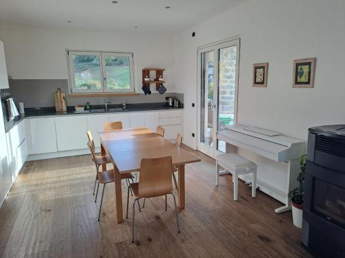 a kitchen and dining room with a table and chairs at Aosta Stunning Panoramic Views From Modern Two Bedroom Apartment in Aosta