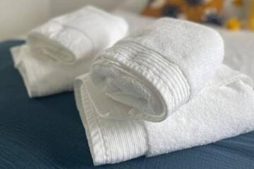 two rolls of white towels sitting on a table at Can Estrellas, appartement d'exception sur la mer in Roses