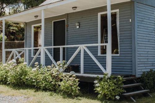 a blue tiny house with a porch and a porch at CABAÑAS TRAPEN in Puerto Montt