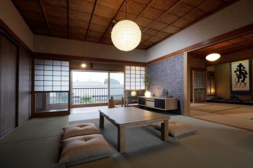 a living room with a table and a couch at Kungin Bettei - Vacation STAY 14605 in Himeji