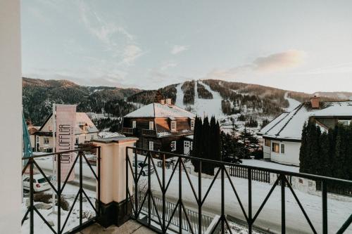 a view from a balcony of a town with snow at Der Löffler am Semmering Bed&Breakfast in Semmering