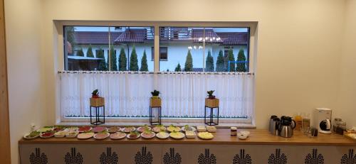 a window with a bunch of food on a table at Willa Nad Białką in Białka Tatrzanska