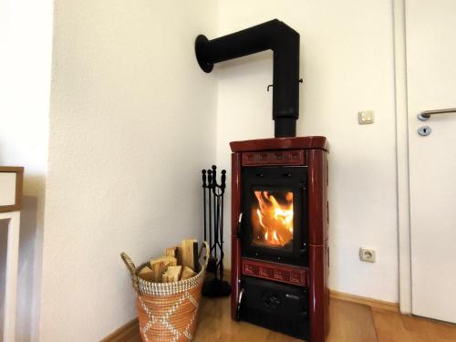 a wood stove in the corner of a room at BohnApartments Juwel am See, mitten in der Natur - gratis Parkplatz - Kamin - WLAN - Nähe Erfurt in Kranichfeld