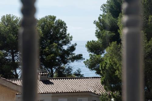 a view of the ocean from a house seen through a window at VILLA WINE & BEACH Design and Luxury in Cala Crancs in Salou