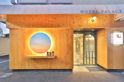 a building with a window with a sunset on it at Hotel Palace Gyeongju in Gyeongju