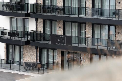 a building with black balconies and tables on the side at A CASA Serenity in Serfaus