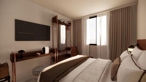 a hotel room with a bed and a flat screen tv at Adonis le Castellet in Signes