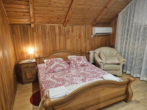 ein Schlafzimmer mit einem Bett und einem Stuhl in der Unterkunft Upeslīči atpūtai in Jelgava