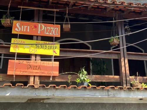 a restaurant with signs on the side of a building at Pé nas trilhas in Rio de Janeiro