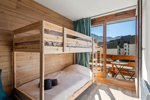 a bunk bed in a room with a balcony at Smartstay Altineige - Val Thorens in Val Thorens