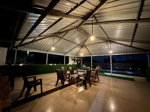 a patio with chairs and a table on a roof at Airspace villa in Igatpuri