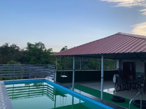 une maison avec une piscine dotée d'un toit en métal dans l'établissement Airspace villa, à Igatpuri