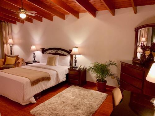 A bed or beds in a room at Casa Bella Boutique Hotel San Isidro