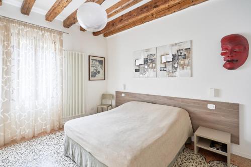 a bedroom with a bed and a large window at Cà Boldo Terrace 2.0 in Venice