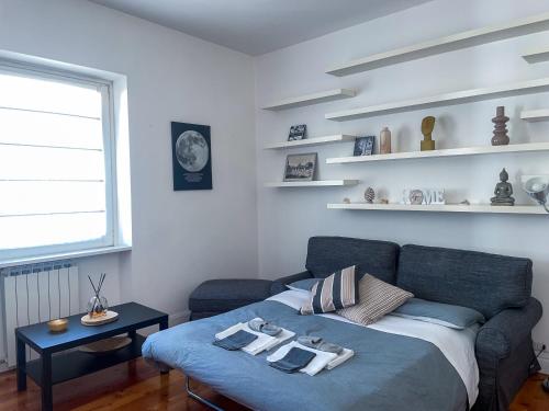 a living room with a blue couch and a table at Domus Montebello in Rome