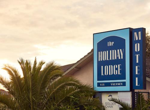 a sign that reads the hollywood lodge at Holiday Lodge Motor Inn in Narooma