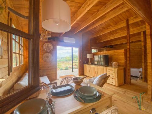 a dining room with a table in a cabin at Vale do Laranjal in Setúbal