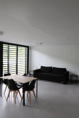 a living room with a couch and a table and chairs at Departamentos Ciudad de Nieva in San Salvador de Jujuy