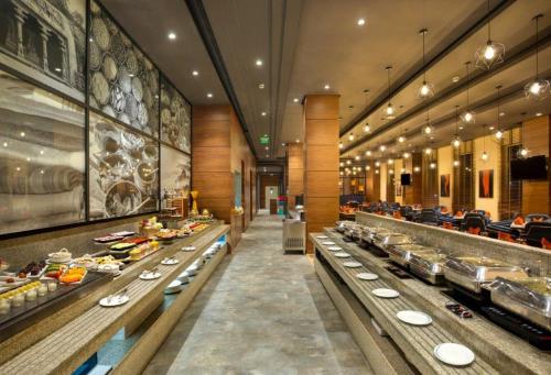 a buffet line in a restaurant with many dishes at Four Points by Sheraton Chennai OMR in Chennai