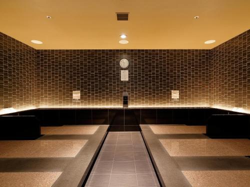 a waiting room with a clock on the wall at Hotel Monterey Kyoto in Kyoto