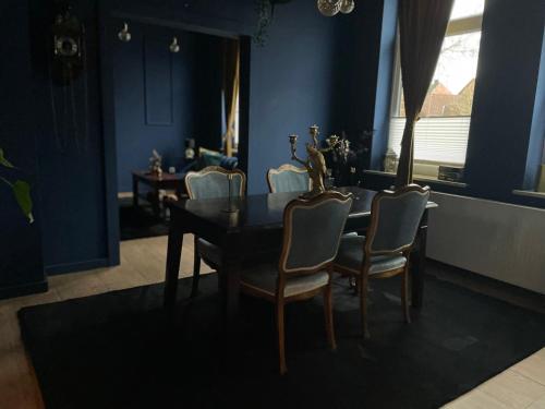 a dining room with a table and chairs at Blue Royal Apartment in Celle