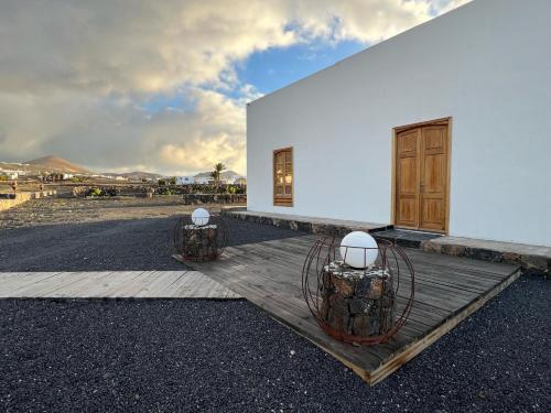 a white building with a wooden door and two lights at Finca Isolina Hotel Boutique - Adults Recommended in Mácher