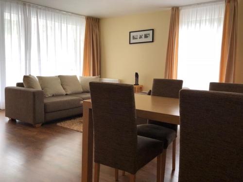 a living room with a couch and a table at Apartman priamo na svahu in Donovaly