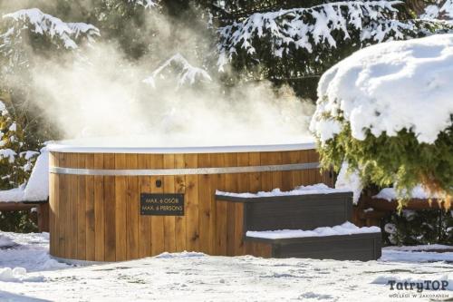 una bañera de hidromasaje con nieve encima en Tatra Resort & SPA, en Kościelisko