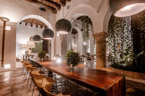 a long wooden table in a room with chairs at Amarla Boutique Hotel Cartagena in Cartagena de Indias