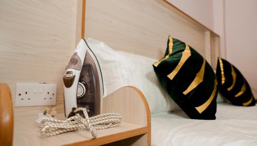 a iron on a table next to a bed at Maya Homes in Naivasha