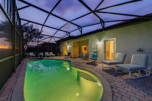 - une piscine dans une maison avec un toit dans l'établissement Dream Villa - New 4BR/3BA - 6 Miles From Disney, à Orlando