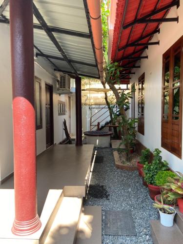 an empty hallway with plants in a building at Dove cottage in Cherai Beach