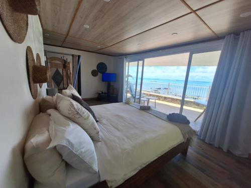 um quarto com uma cama grande e vista para o oceano em Les 2 canons em Flic-en-Flac