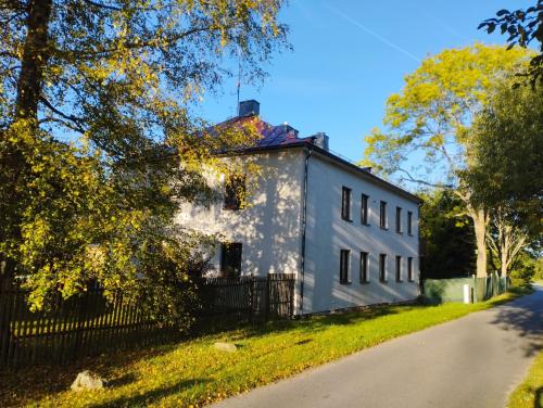 a white house on the side of a road at Apartmány Lipno-Hory in Horní Planá