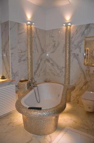 a bathroom with a bath tub with two lights on it at Gemütliche Apartment Lucky und Lucky de Luxe in Bremerhaven