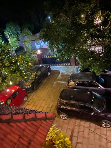 a group of cars parked in a parking lot at night at Dove cottage in Cherai Beach