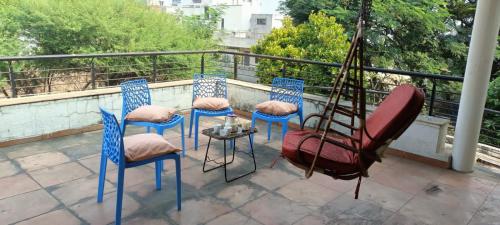 a group of chairs and a table on a balcony at Ram@nasik in Nashik