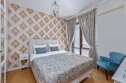 una camera con letto e sedia blu di HCG Panorama Villa Deluxe Apartment a Bakuriani