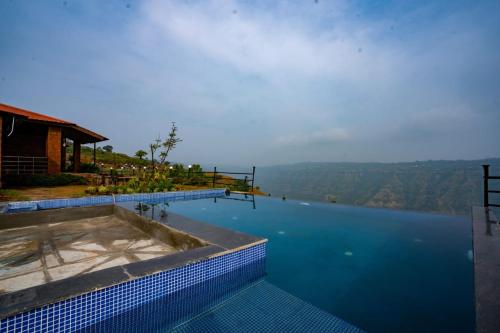 una piscina con vistas al agua en Lifeline Villas - Miracle 5BHK Infinity Pool Villa With Breathtaking Valley View And Huge Lawn Area, en Mahabaleshwar