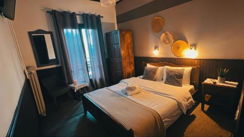 a bedroom with a bed with a stuffed animal on it at Pilioritiko Spiti in Makrinítsa