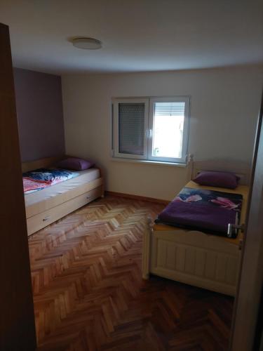 Habitación pequeña con 2 camas y ventana en Z A M A K, en Niška Banja