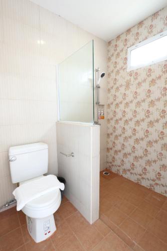 uma casa de banho com um WC branco e um espelho. em Rak Na Khaoyai em Mu Si