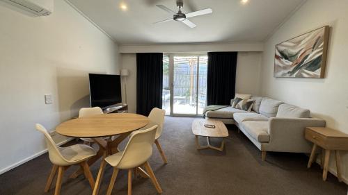 a living room with a couch and a table at Torquay Hotel/Motel in Torquay