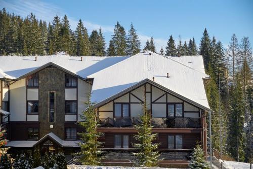 a house in the mountains with trees at MK Resort (ex. Magiya Karpat) in Bukovel