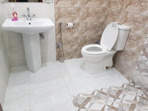 a bathroom with a toilet and a sink at Roof Top Resort in Murree