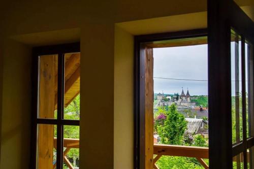 a view of a castle from a window at Tisnyi 7 Guest House in Kamianets-Podilskyi